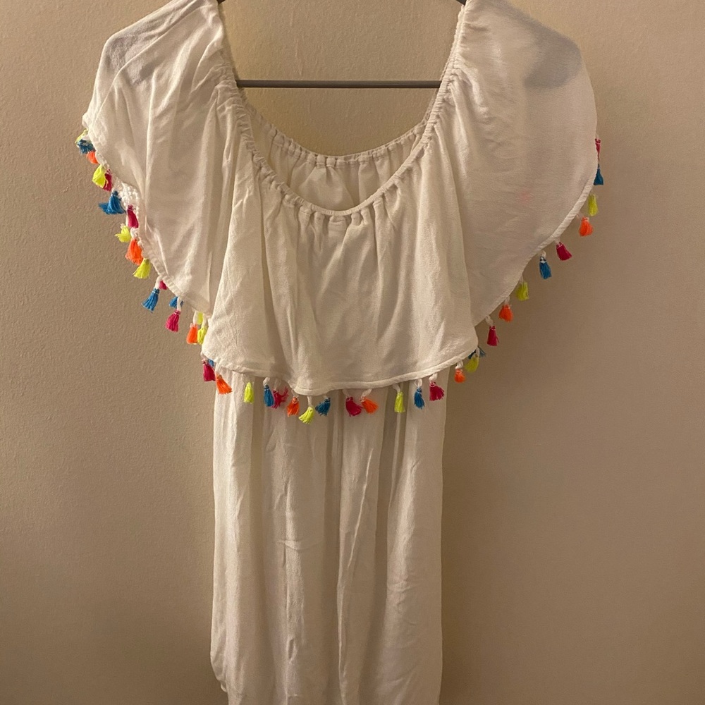 White off-the-shoulder dress with colorful tassels